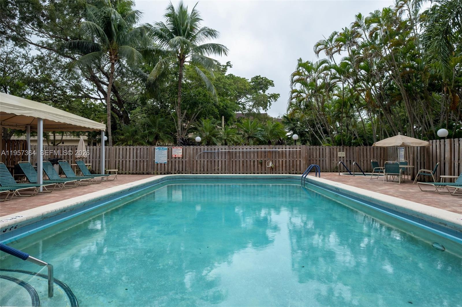 6800 Cypress Road, Unit 501 Plantation, FL 33317 - Photo 36 of 40 a swimming pool with outdoor seating and yard
