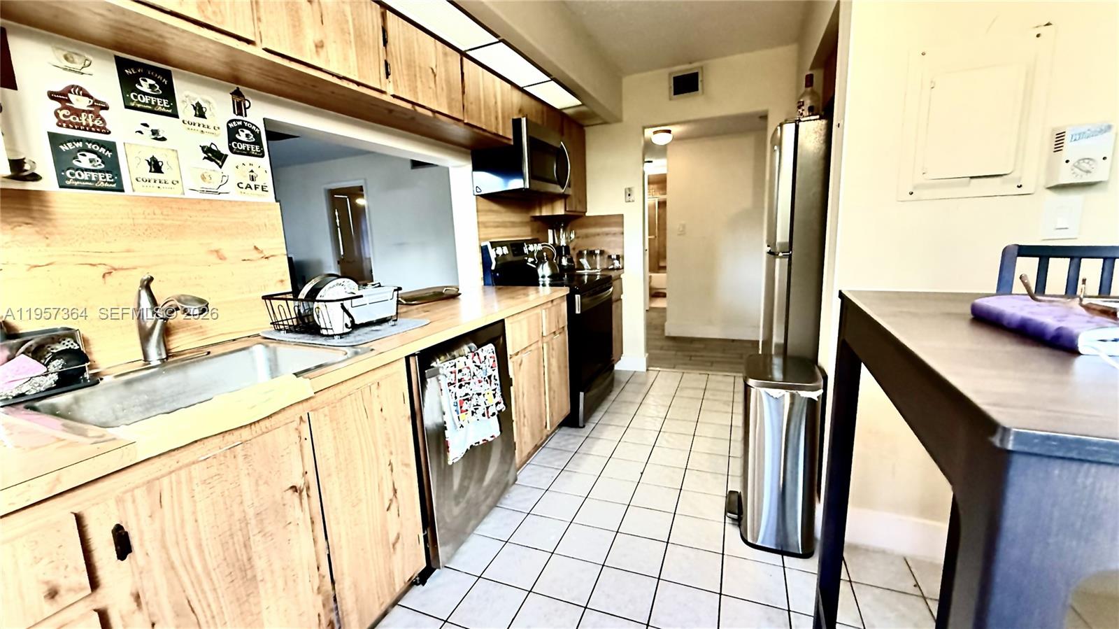 6800 Cypress Road, Unit 501 Plantation, FL 33317 - Photo 4 of 40 a kitchen with sink refrigerator and stove