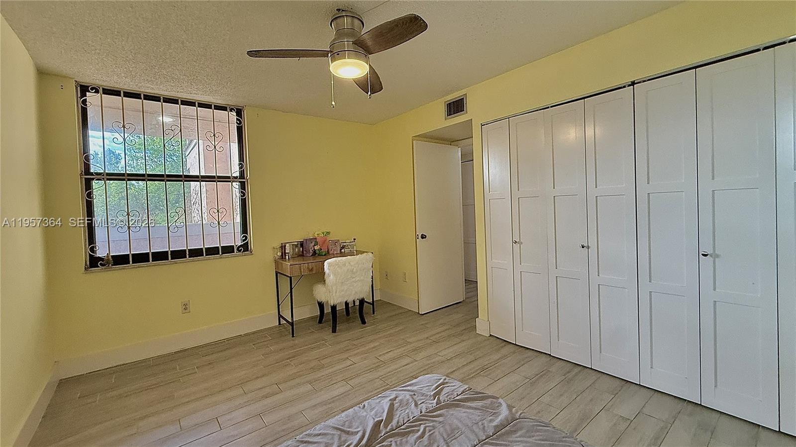 6800 Cypress Road, Unit 501 Plantation, FL 33317 - Photo 8 of 40 a view of a room with wooden floor fan and windows