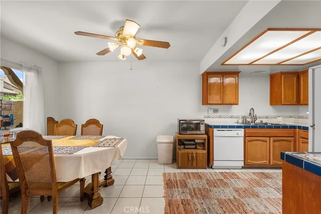 a kitchen with stainless steel appliances granite countertop a refrigerator a sink dishwasher a stove with wooden cabinets