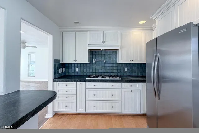 a kitchen with granite countertop a cabinets and steel stainless steel appliances