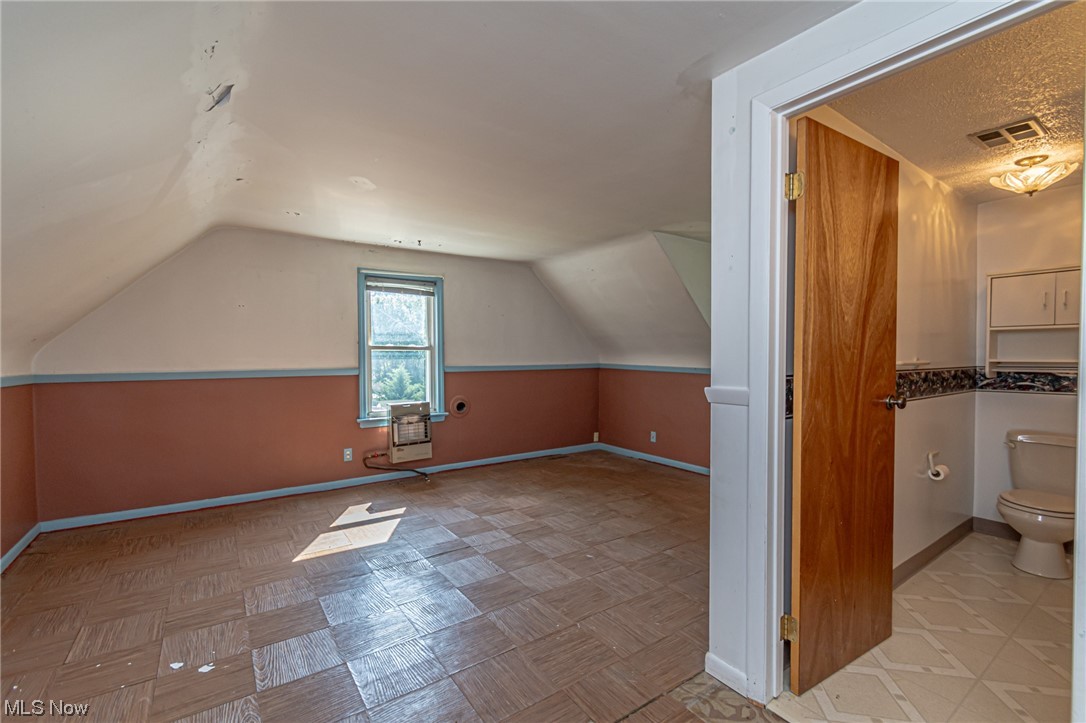 8358 Ridge Road North Royalton, OH 44133 - Photo 22 of 25 Bonus room featuring a textured ceiling and lofted ceiling