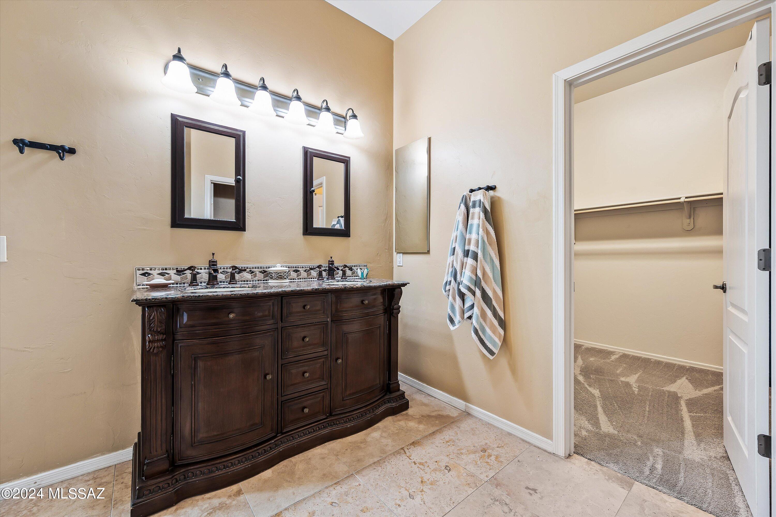 8579 North Shadow Wash Way Tucson, AZ 85743 - Photo 25 of 34 a bathroom with a sink a vanity and a mirror