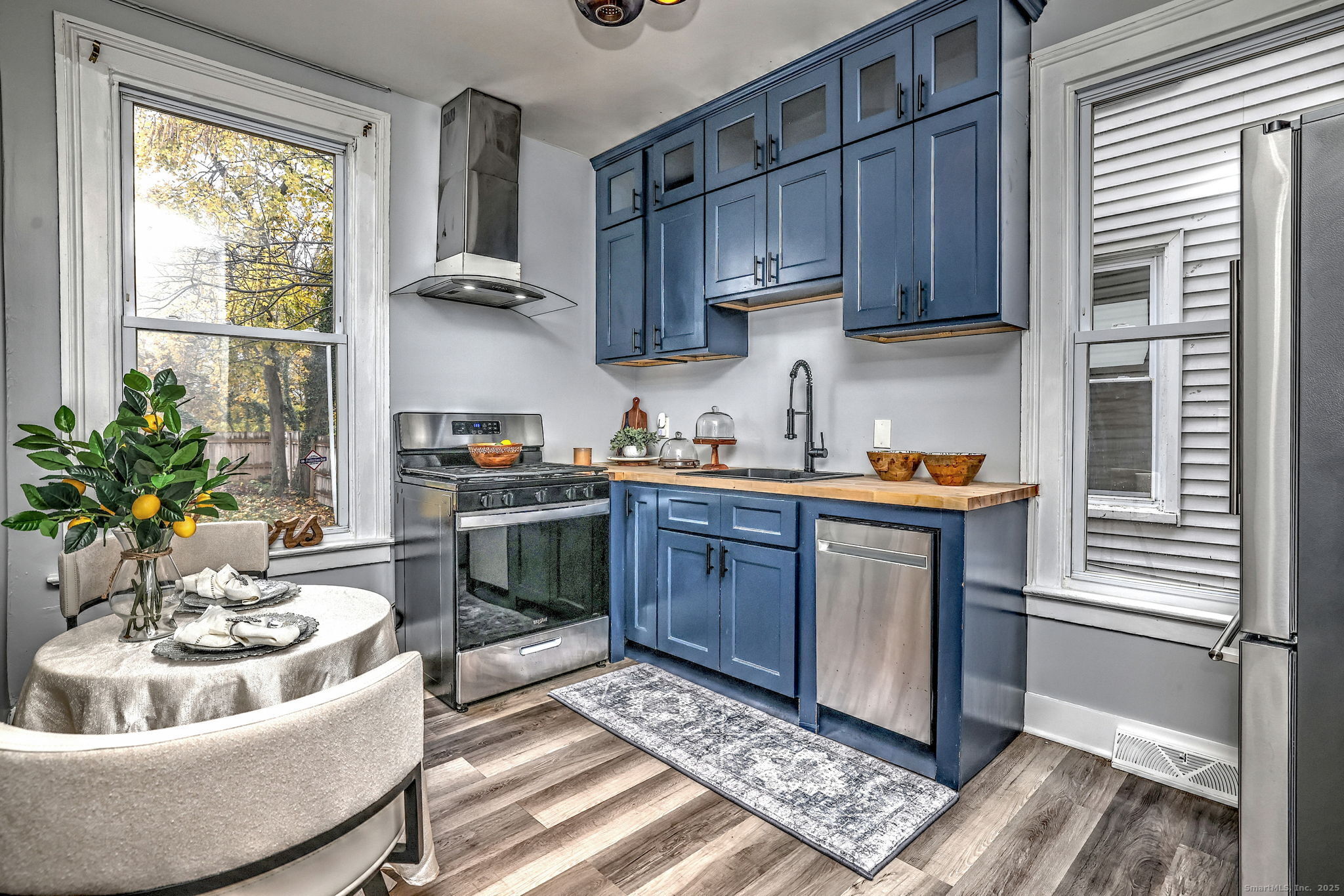 6 Gilbert Avenue New Haven, CT 06511 - Photo 1 of 1 a kitchen with stainless steel appliances granite countertop a sink a stove a refrigerator cabinets and a window