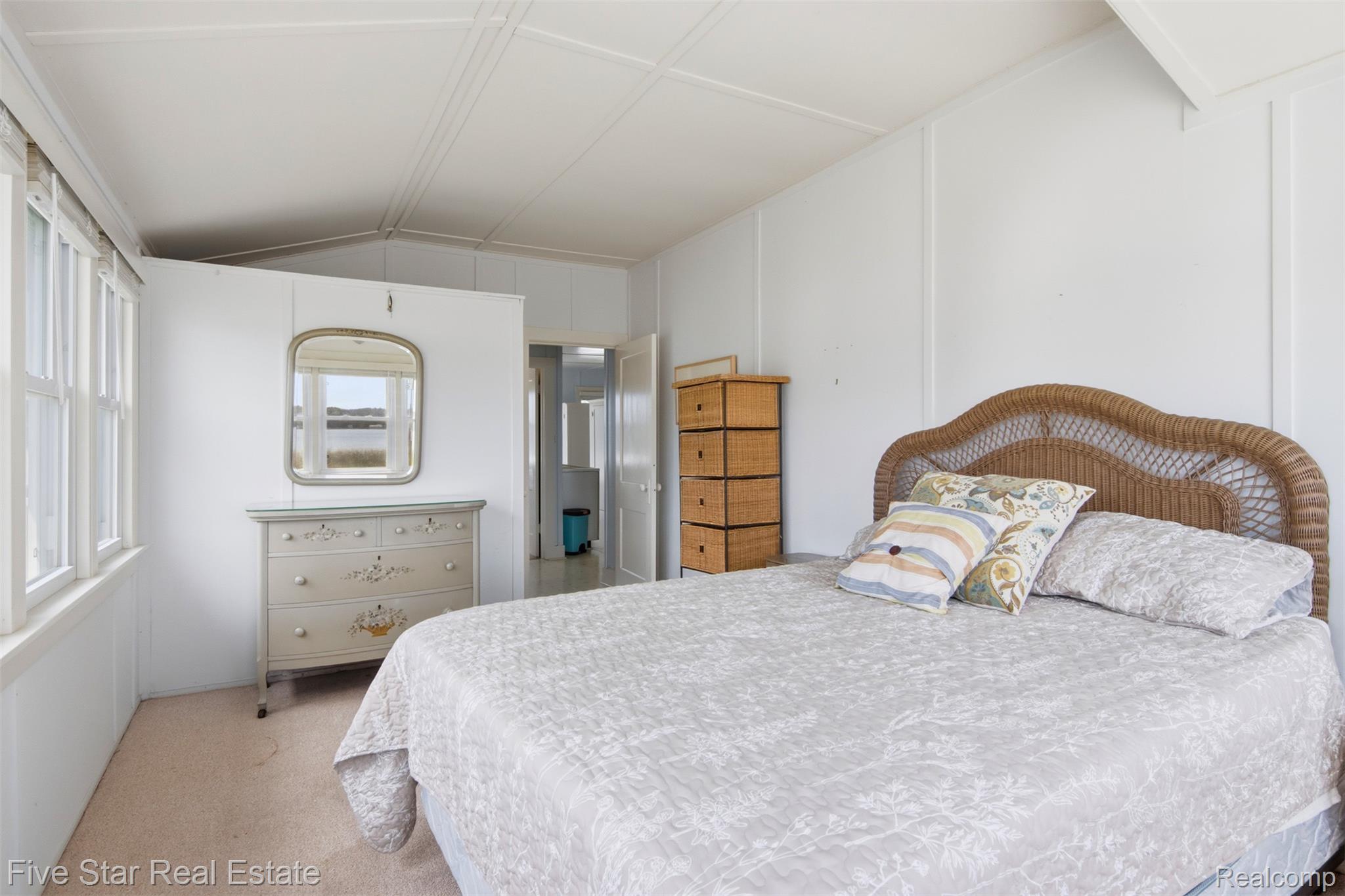 2588 Lakeview Road Onekama, MI 49675 - Photo 21 of 32 Interior room with white paneled walls, white trim, and light carpeting
