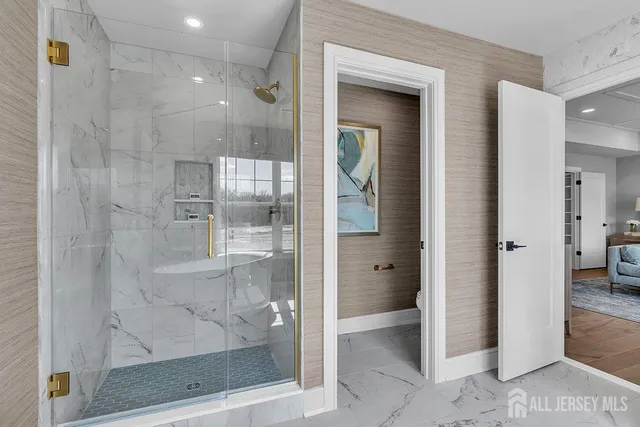 a bathroom with a glass shower door and a toilet