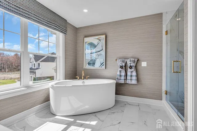 a spacious bathroom with a bathtub and next to a window