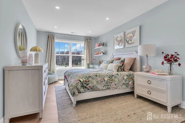 a bedroom with a large bed and a window