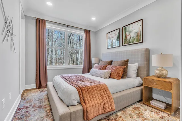 a bedroom with a large bed and a window