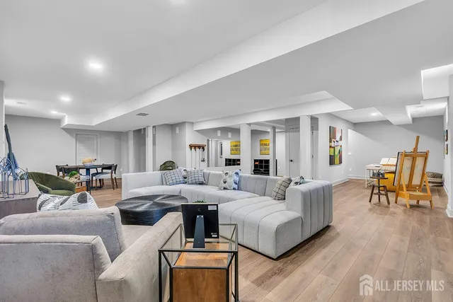 a living room with furniture and wooden floor
