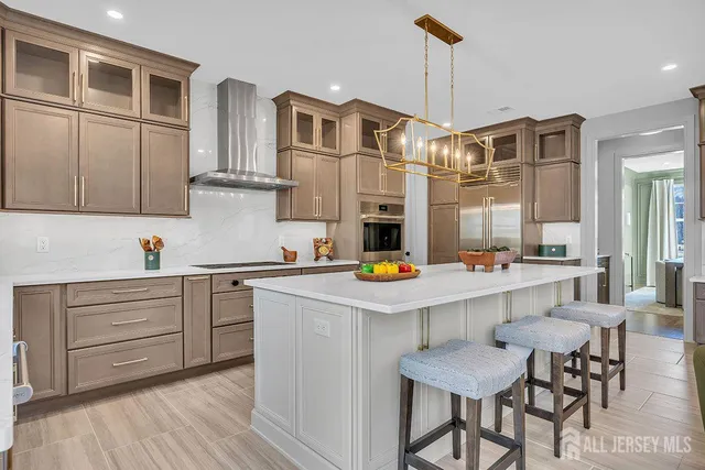 a kitchen with a dining table chairs sink and cabinets
