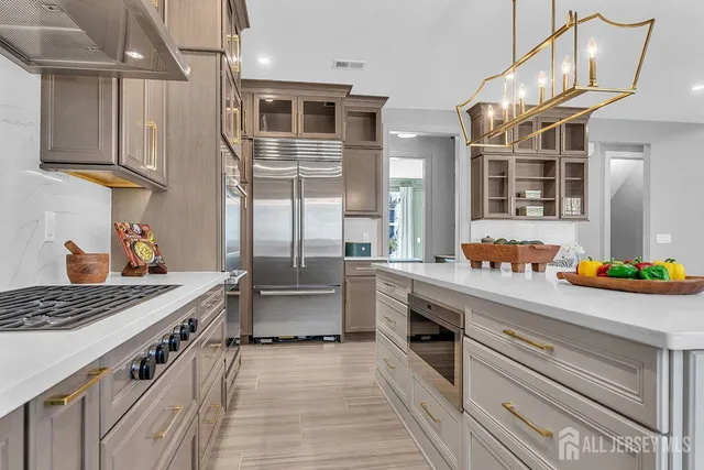 a kitchen with stainless steel appliances a sink stove and cabinets