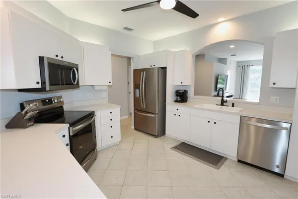 a kitchen with stainless steel appliances a refrigerator stove microwave and sink