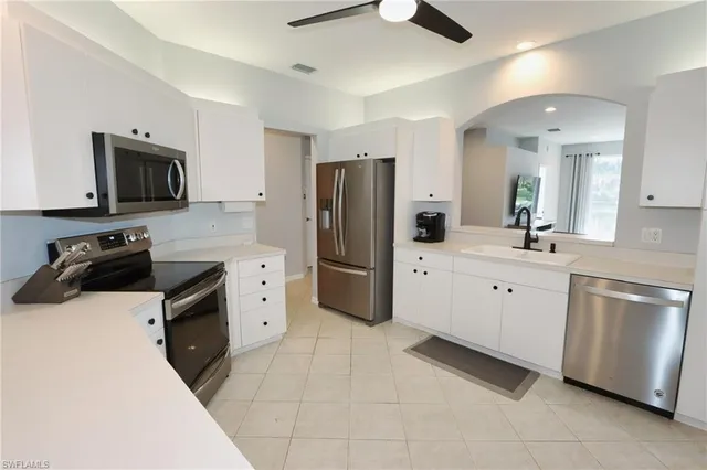 a kitchen with stainless steel appliances a refrigerator stove microwave and sink