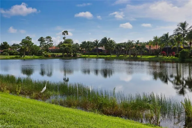 a view of a lake with a house in the background