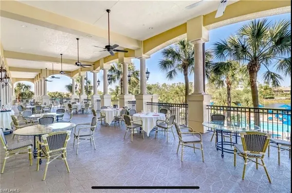 a view of a patio with chairs and tables