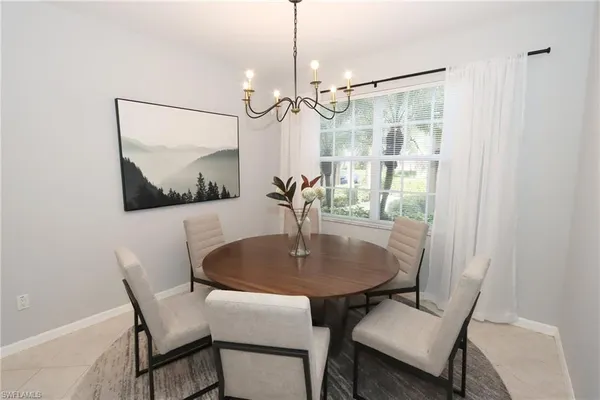 a dining room with furniture and window