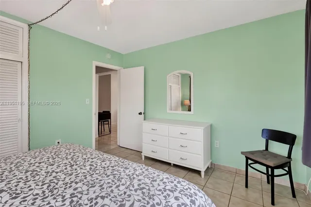 a bedroom with a bed and a chair in it