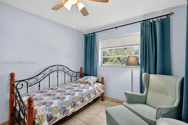 a bedroom with a bed window and couch