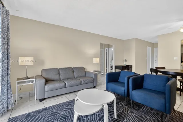 a living room with furniture a couch and a rug