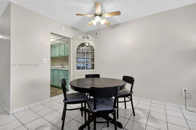a view of a dining room with furniture and a chandelier