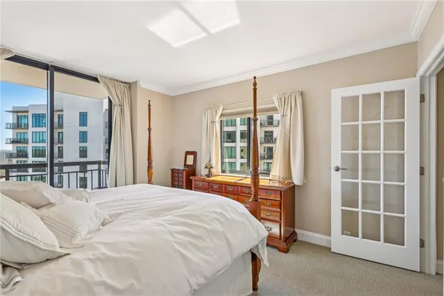 a bedroom with a large bed and a window
