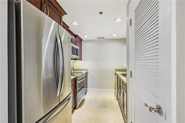 a view of a kitchen with stainless steel appliances