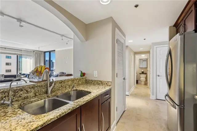a kitchen with a refrigerator sink and mirror