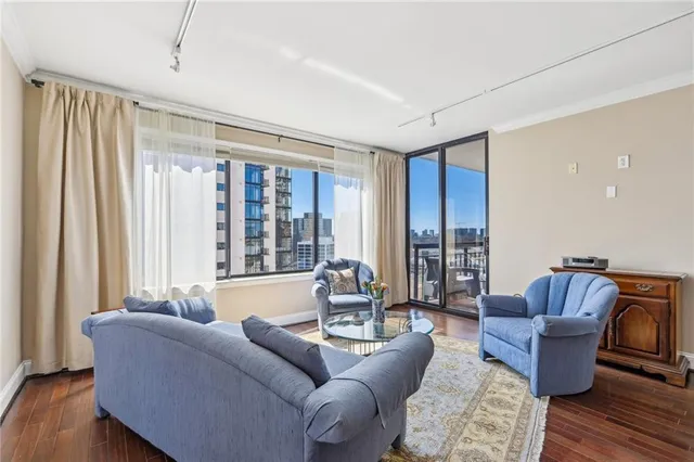a living room with furniture and wooden floor