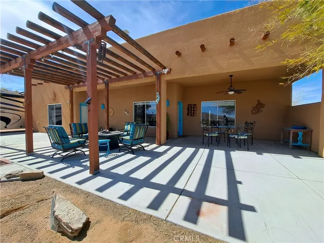 a view of a patio with table and chairs with wooden floor and fence
