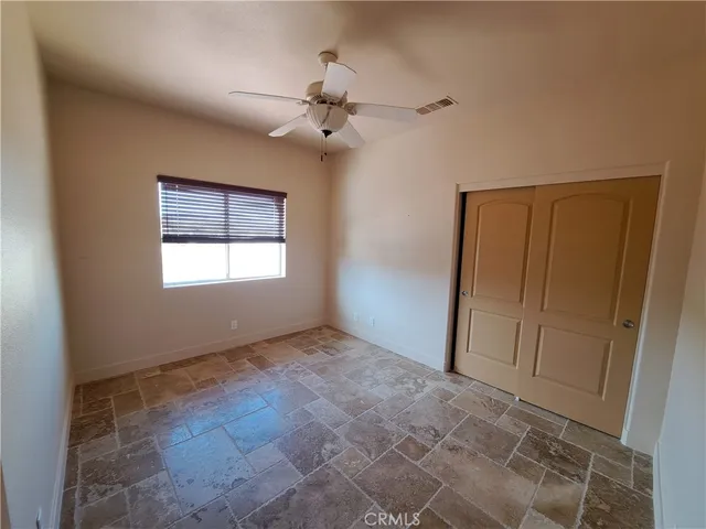 a bathroom with a granite countertop toilet sink and mirror