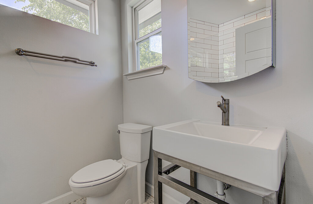 2406 East 16th Street Austin, TX 78702 - Photo 12 of 39 a white toilet sitting next to a bathroom sink