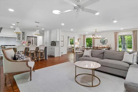 a living room with furniture a dining table and kitchen view