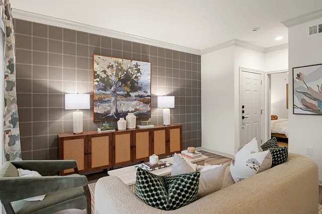 a living room with furniture and a potted plant