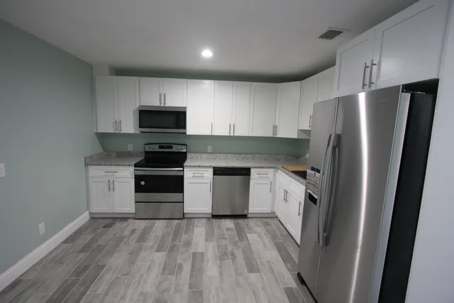 a kitchen with a refrigerator stove and sink