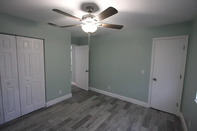 an empty room with wooden floor