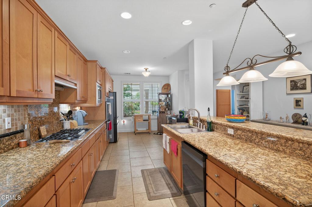 1423 Windshore Way Oxnard, CA 93035 - Photo 77 of 77 a kitchen with a sink stove and cabinets