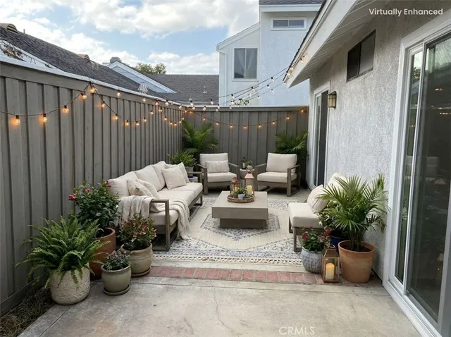 a view of a patio with table and chairs and wooden fence