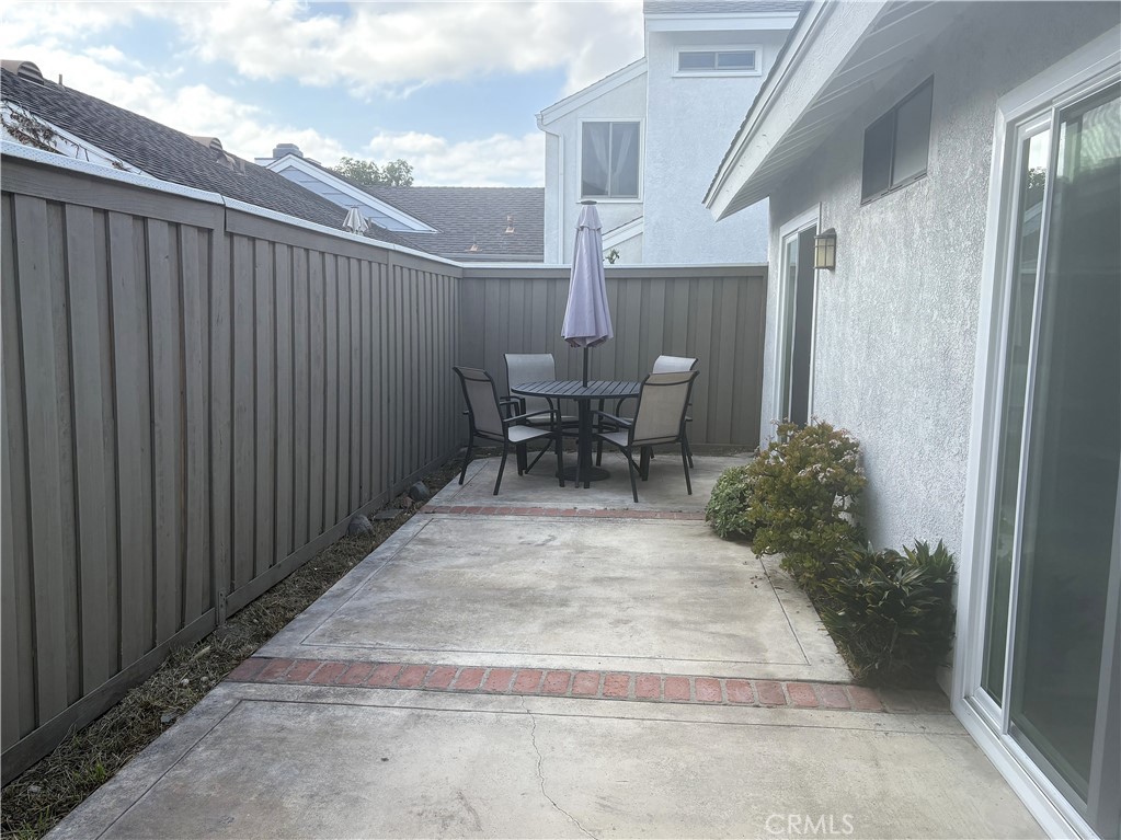 16 Amberleaf Irvine, CA 92614 - Photo 12 of 18 So much patio space with 2 sliders --one from the dining room and 1 from the primary bedroom. A new fence here too.