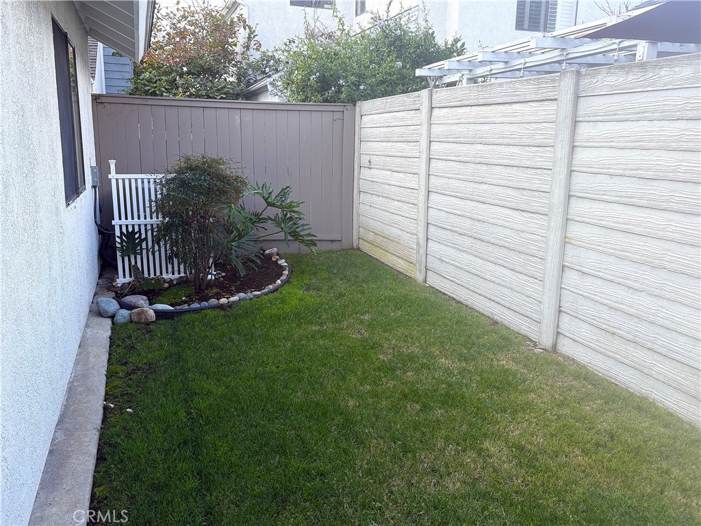 16 Amberleaf Irvine, CA 92614 - Photo 14 of 18 Front yard has recently replaced fencing and the newer AC condenser is hidden in the corner.