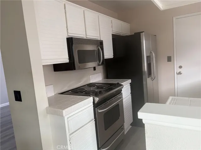 a bathroom with a granite countertop sink and mirror