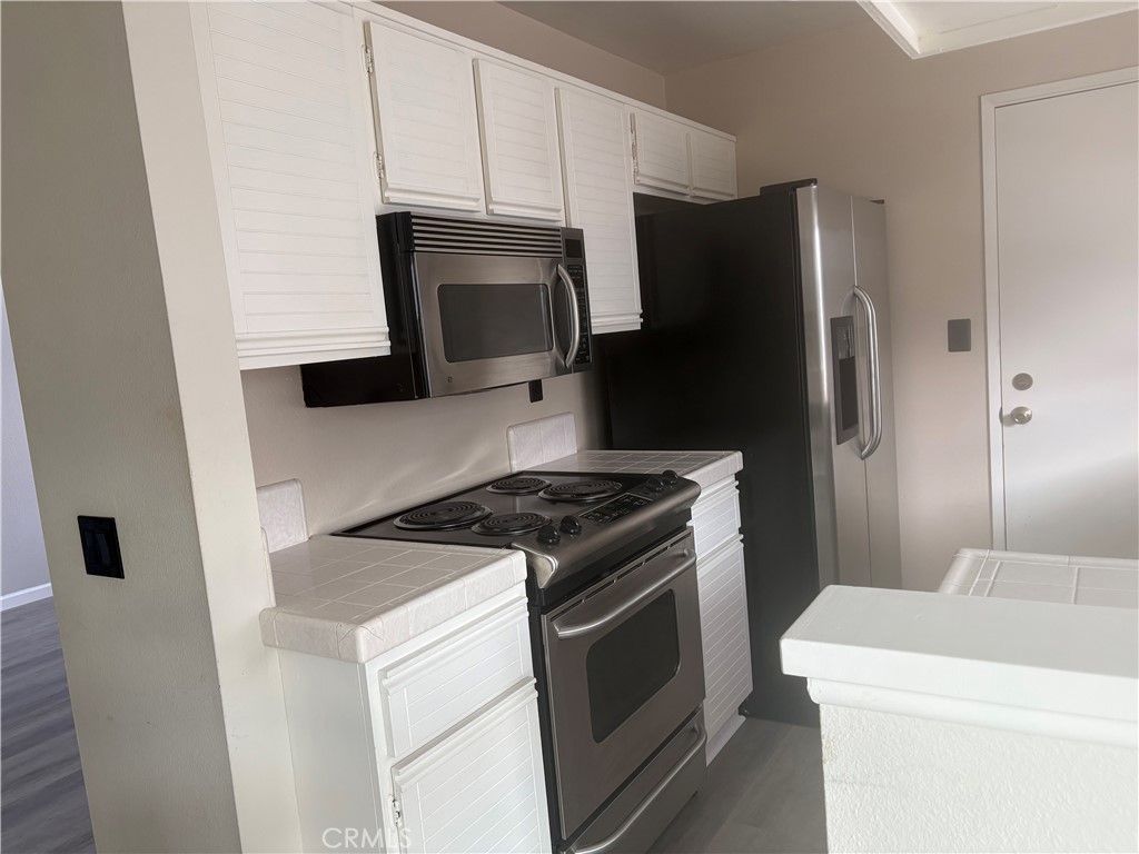 16 Amberleaf Irvine, CA 92614 - Photo 15 of 18 Sparkling white cabinets and stainless appliances.