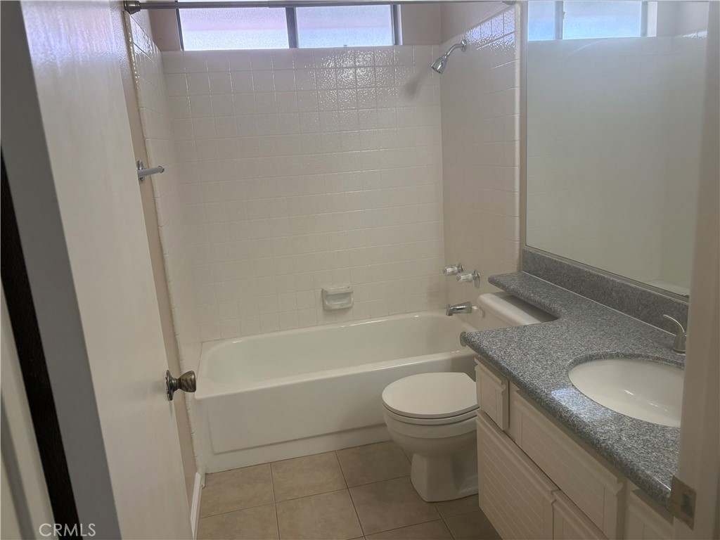 16 Amberleaf Irvine, CA 92614 - Photo 17 of 18 Guest bath with a shower over the tub and granite counters for the vanity.