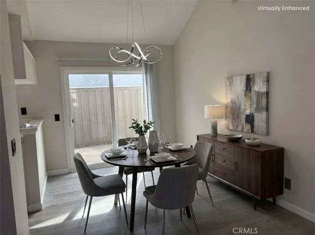 a dining room with furniture a chandelier and window