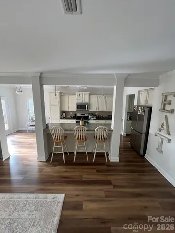 a dining room with furniture and wooden floor