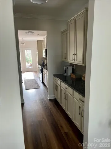a kitchen with granite countertop a sink and cabinets