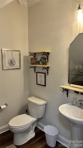 a bathroom with a toilet a sink and mirror