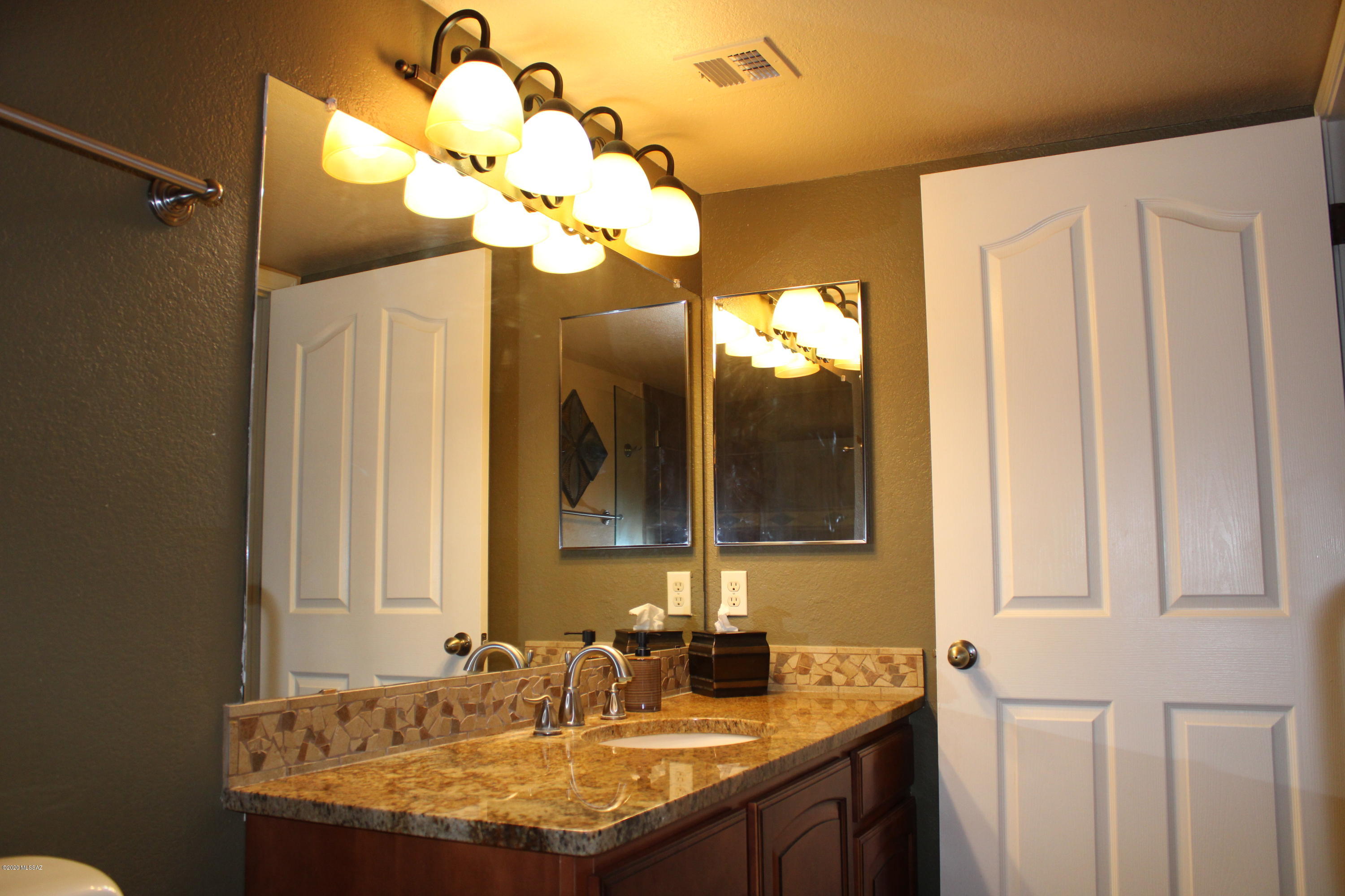 5751 North Kolb Road, Unit 36203 Tucson, AZ 85750 - Photo 15 of 25 a bathroom with a granite countertop sink and a mirror