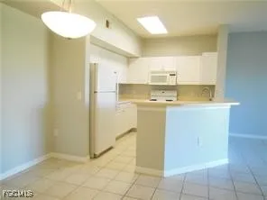 a kitchen with a sink a stove a refrigerator and cabinets