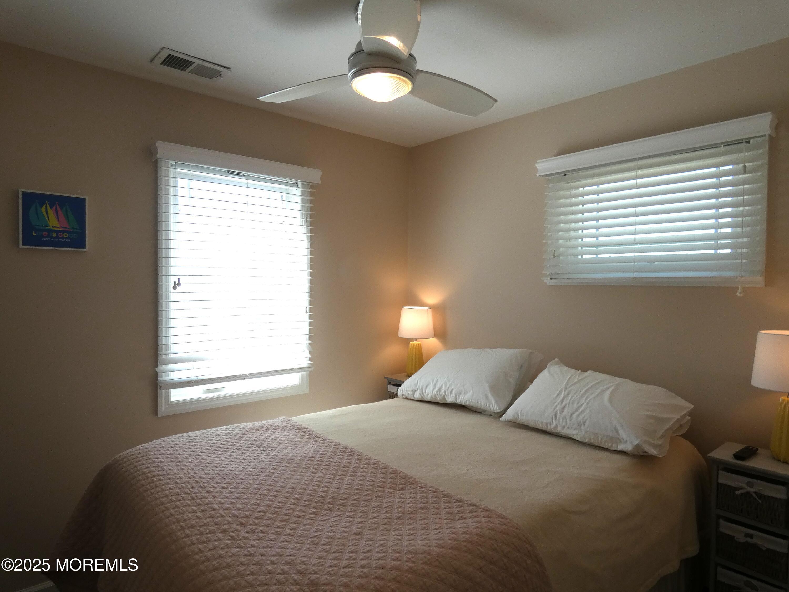 3420 Seaview Road Lavallette, NJ 08735 - Photo 15 of 44 a bedroom with a bed and a window